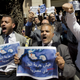 FILE - In this Tuesday, June 13, 2017, file photo, dozens of lawyers shout slogans during a protest against the accord to hand over control of two strategic Red Sea islands, Tiran and Sanafir, to Saudi Arabia in front of the lawyers syndicate in Cairo. The tempestuous parliament approval of a deal transferring two Red Sea islands to Saudi Arabia is putting Egypt’s government at odds with the judiciary and providing the country’s battered opposition a nationalist cause to whip up at a time of growing economic distress. Arabic on the Red Sea map reads, " bread.. freedom, the islands are Egyptians".
